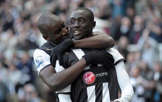 Demba Ba hugs strike partner Papiss Cisse