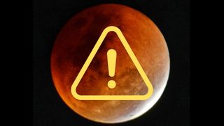 graphic showing a blood red moon during a lunar eclipse with a small portion of the moon still illuminated bright white. there is a yellow exclamation mark within a triangle graphic in the foreground.