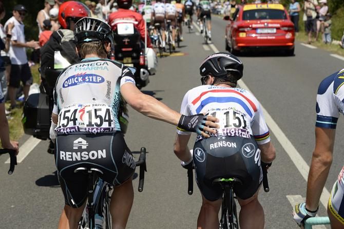 Mark Cavendish is helped back to the peloton by Tony Martin