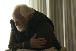 James Cosmo as Jim Mackie in Six Four, with his arms folded looking down