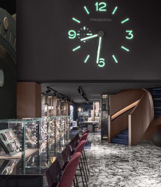 dark wood-filled shop interior with projected clock