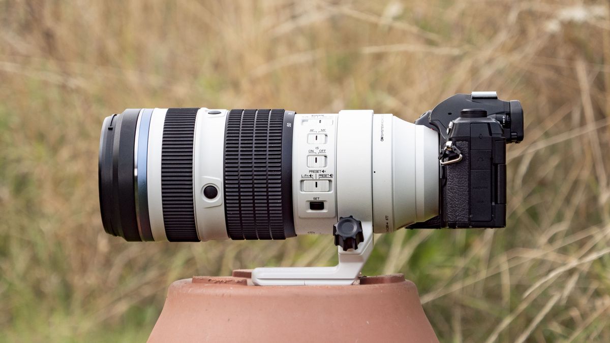 OM System M.Zuiko Digital ED 50-200mm F2.8 IS Pro lens attached to an OM-1 II, outdoors with long grass in the background