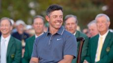 Rory McIlroy smiles while sitting at The Masters presentation ceremony in 2025