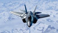 An F-35 Lightning II flying over snow-capped mountains