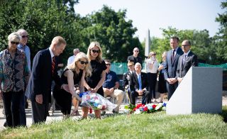 Family members of Apollo 1 astronaut Edward White are joined by NASA Administrator Bill Nelson as they place flowers at the Apollo 1 monument on June 2, 2022.