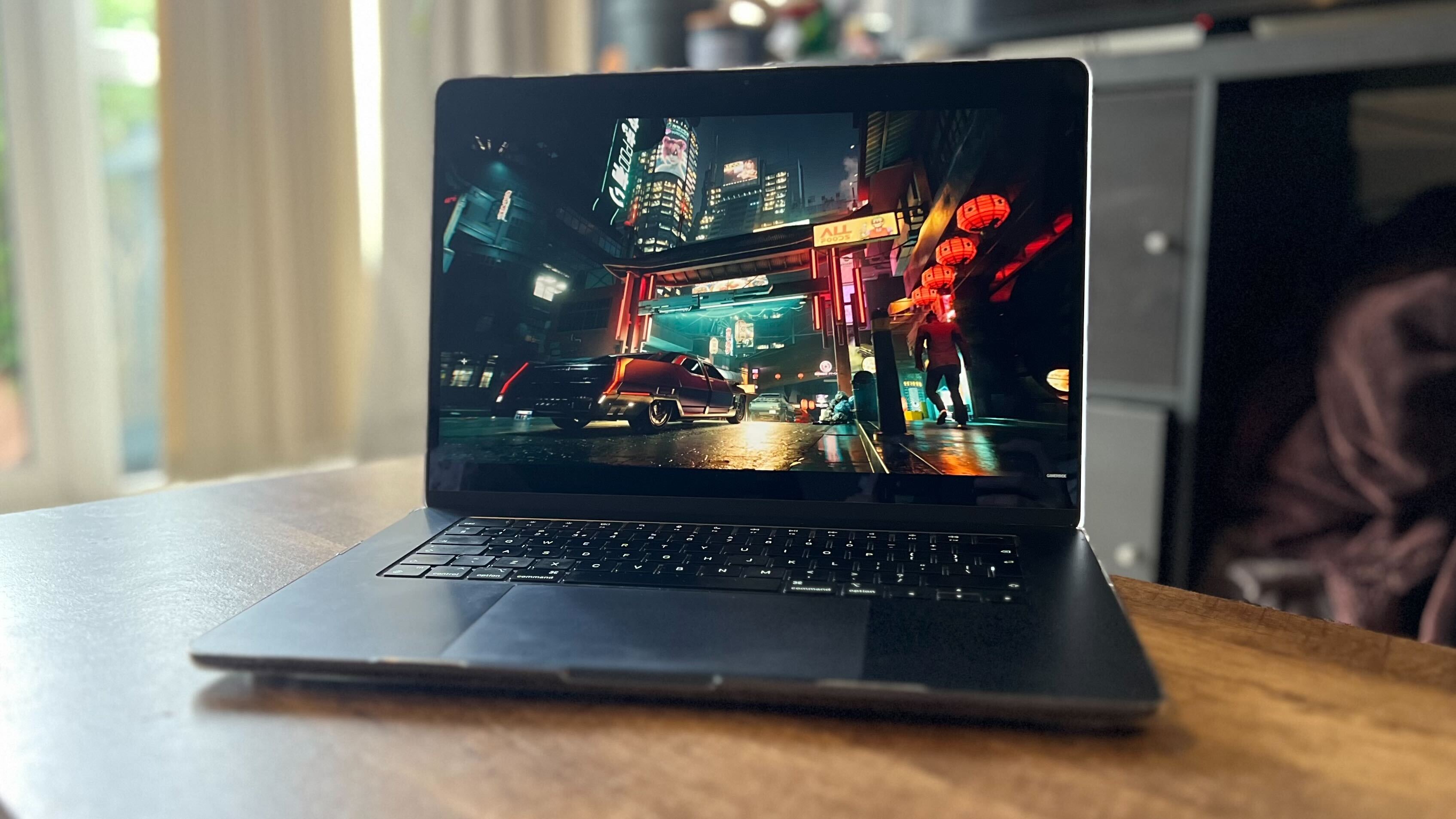 Apple MacBook Air displaying an image of Cyberpunk 2077 on a wooden table