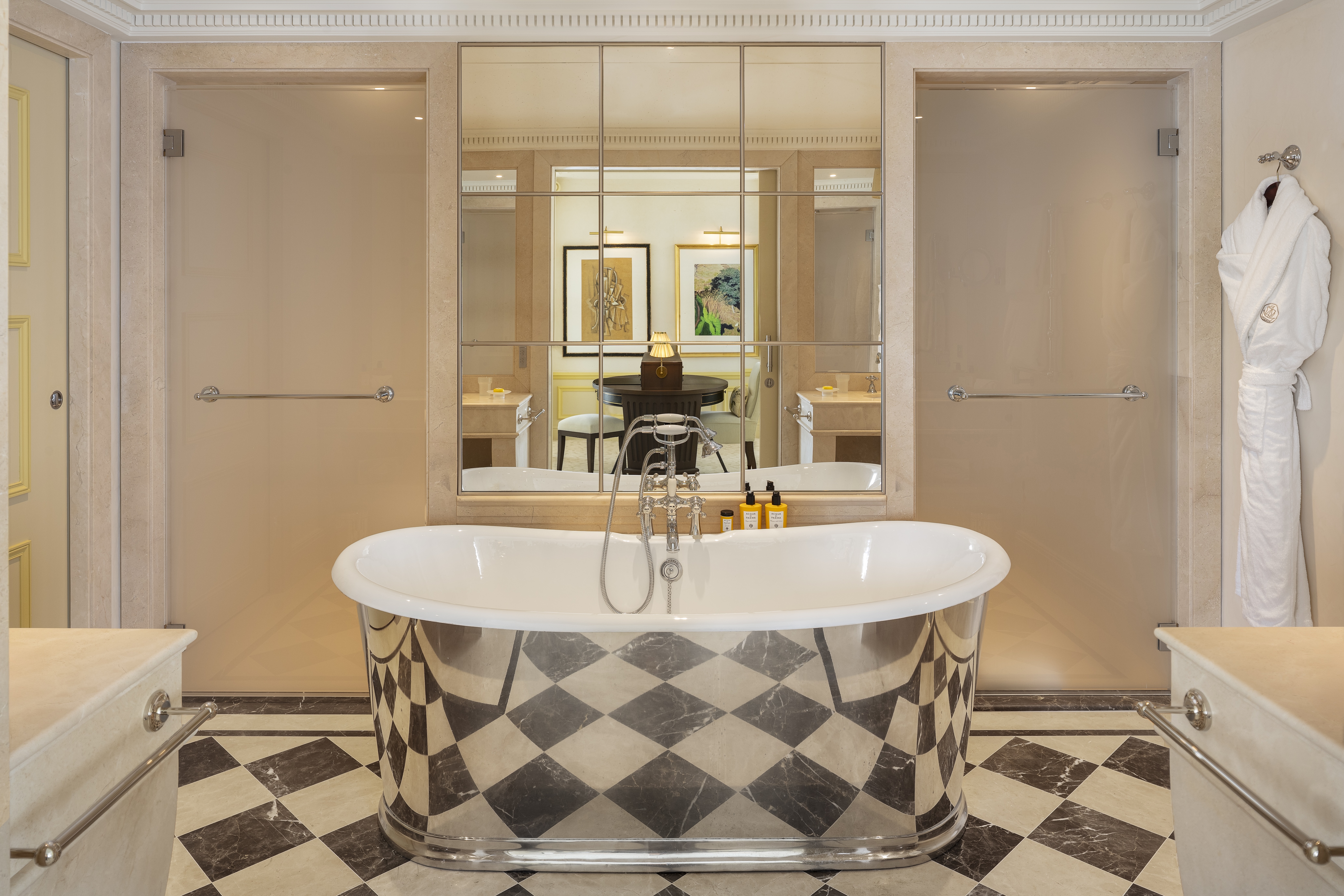 Silver roll-top bath on a checkerboard floor