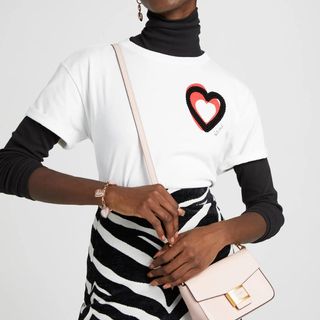 model wearing white kate spade tee with overlapping hearts motif