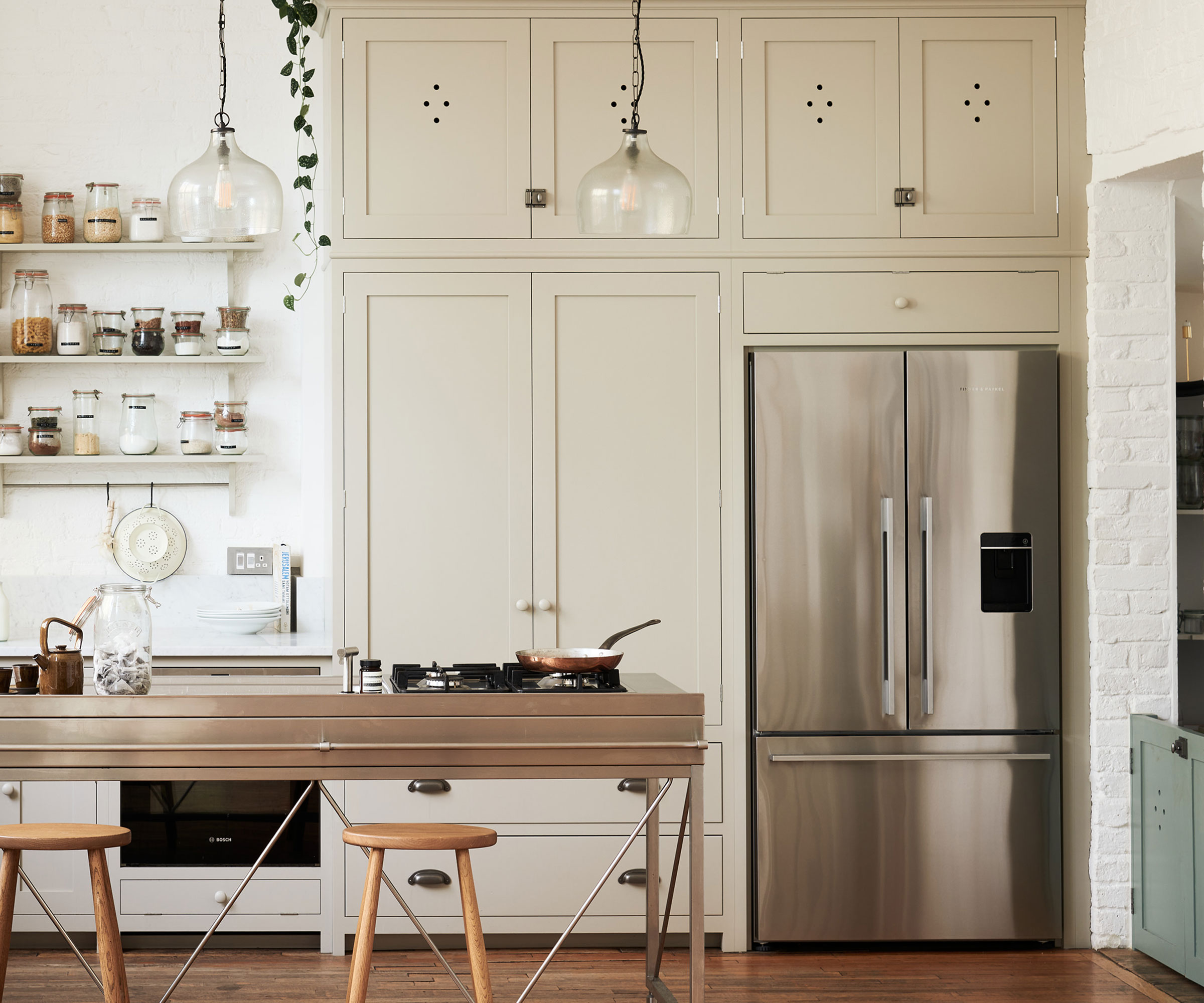 white Shaker kitchen with stainless steel kitchen island and American style fridge freezer