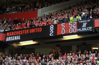 The Old Trafford scoreboard shows Manchester United 8 Arsenal 2 in 2011