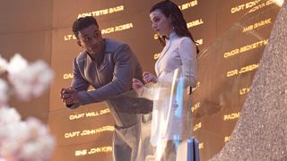 Characters chilling out in front of the memory wall. 