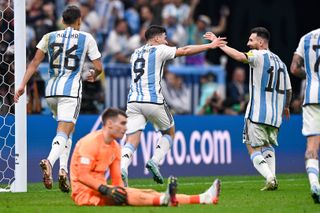 Julian Alvarez celebrates with Lionel Messi after scoring for Argentina against Croatia in the 2022 World Cup semi-finals.