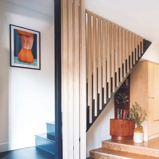 Wooden panelled staircase with empty slats between.