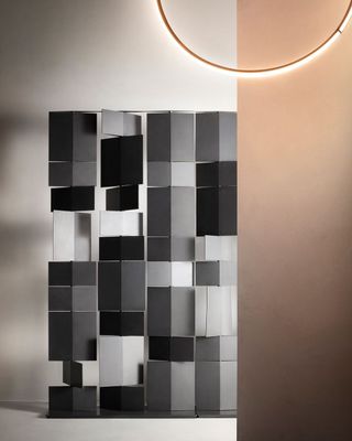 A room divider made of black and grey panels by MDF Italia