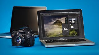 Nikon D800 next to a pair of MacBook Pro laptops, against a blue background