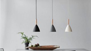 three grey scandi pendant kitchen island lights suspended over a table