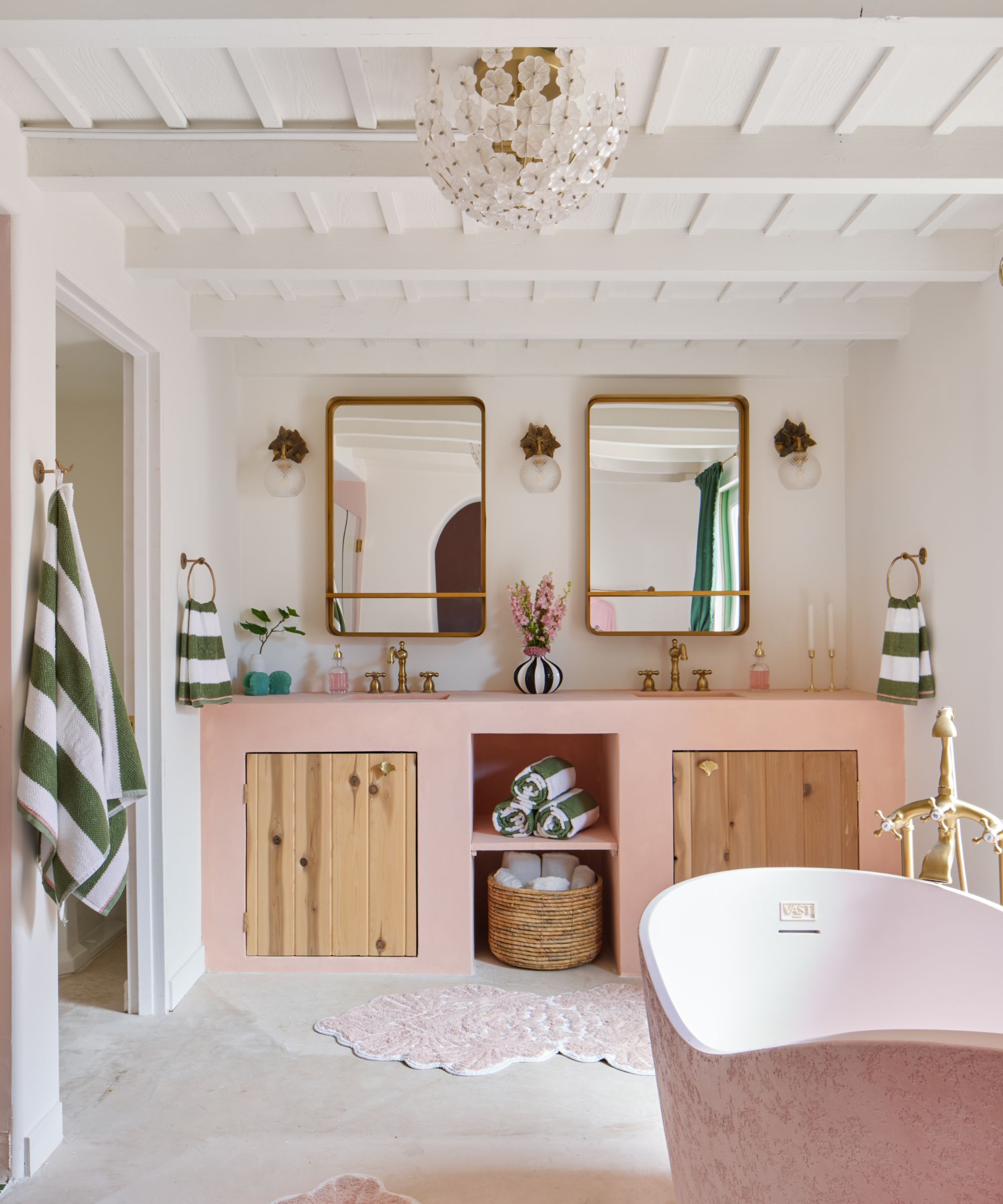 A large bathroom with a concrete vanity with wooden doors