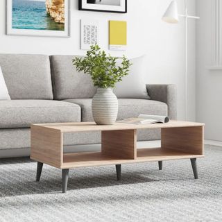 A wooden coffee table in front of a couch.
