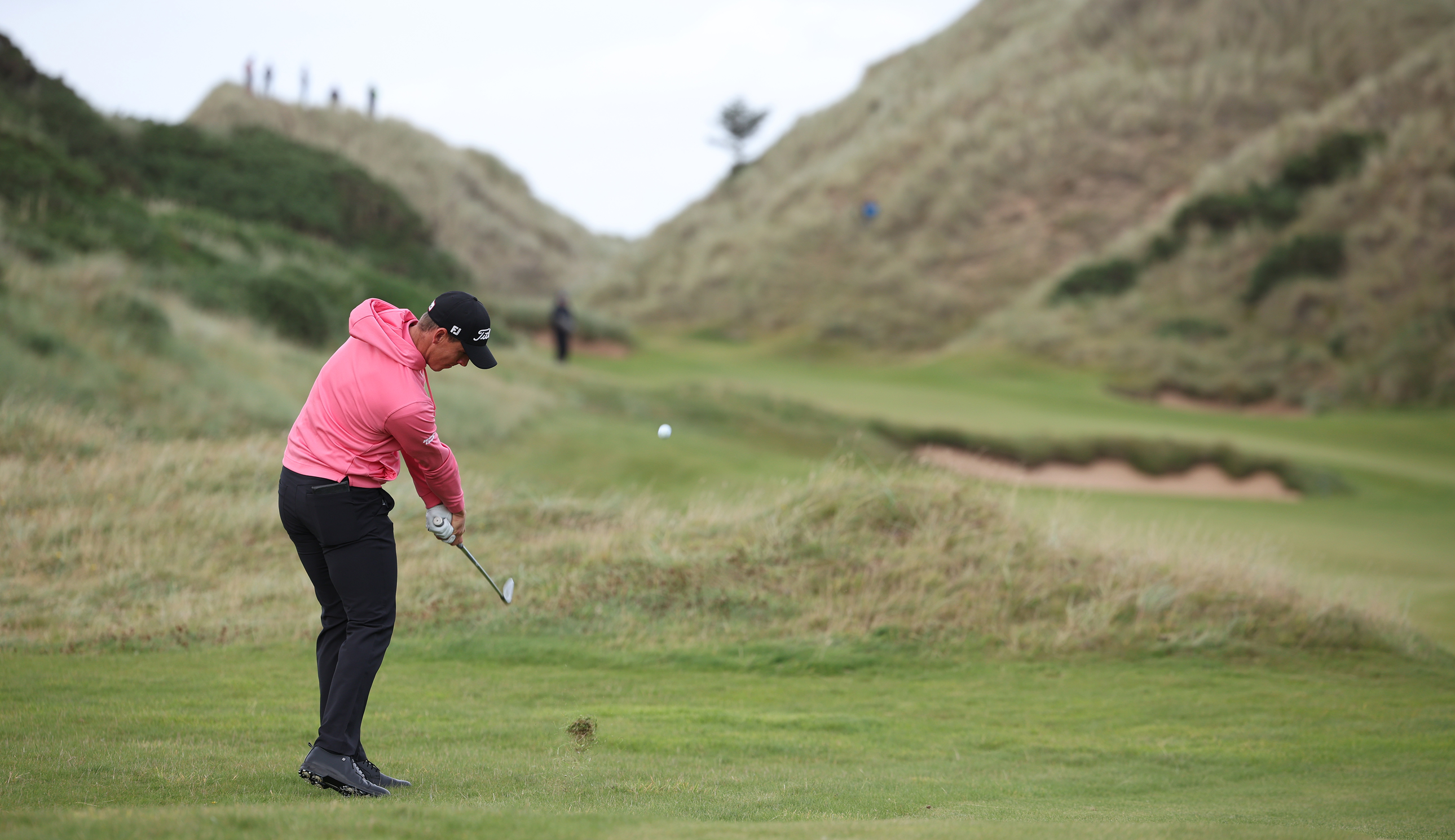 Grant Forrest hits an iron shot into the green
