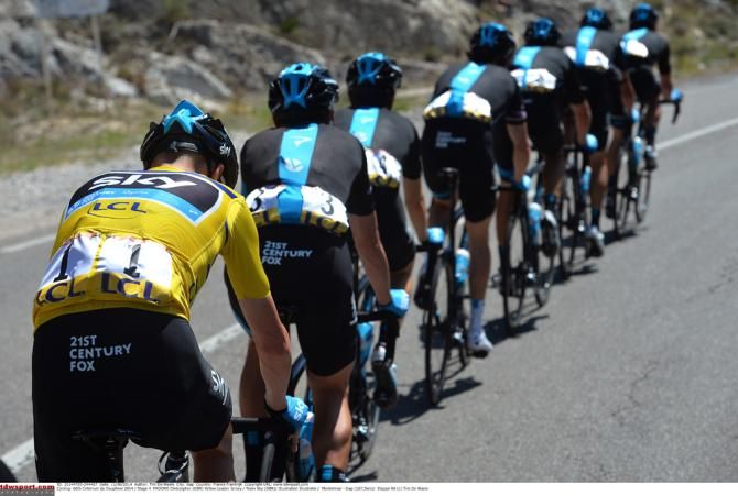 Chris Froome (Team Sky) lets his teammates pace him back after a fall at the Dauphine