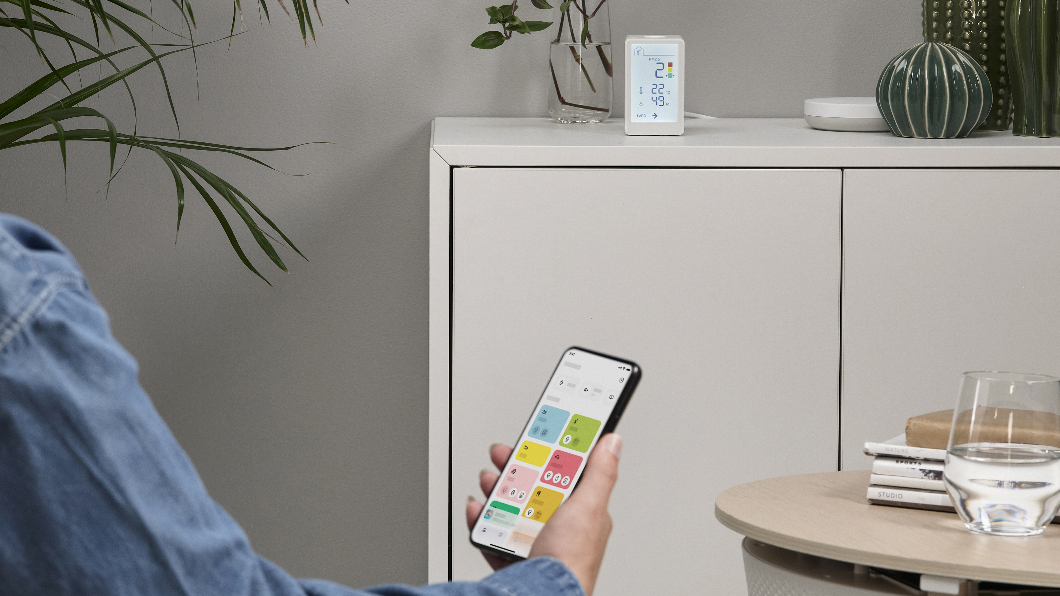 The IKEA VINDSTYRKA smart air quality monitor on a table