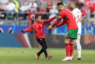 Cristiano Ronaldo was stopped by a young fan for a picture during Portugal's win over Turkey at Euro 2024