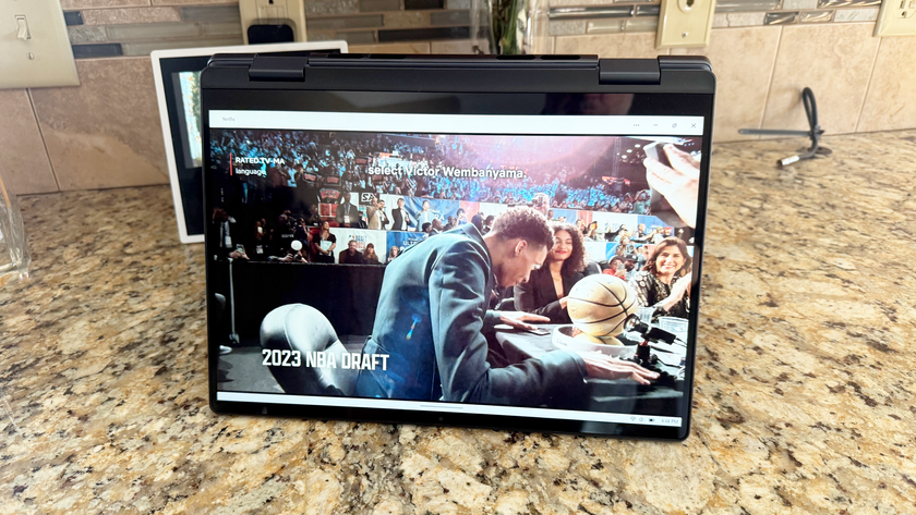 A Dell Inspiron 14 2-in-1 laptop playing Netflix on a kitchen counter.