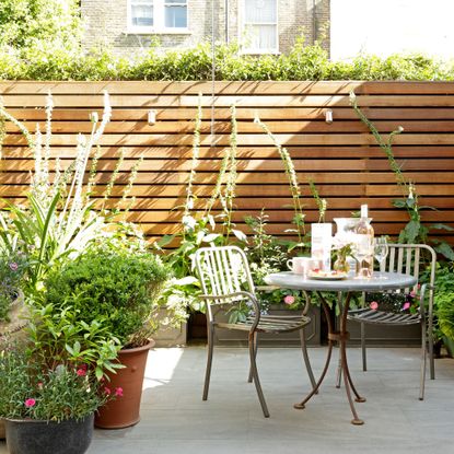 patio area with bistro set and planting