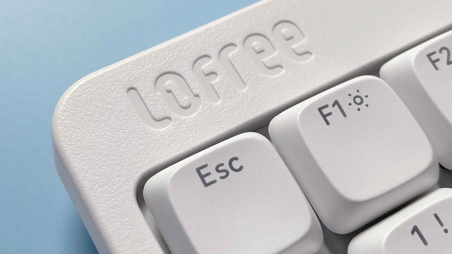 The Lofree Flow Lite mechanical keyboard against a blue background.