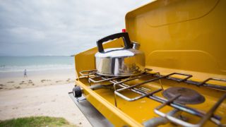 best camping stoves: A kettle heating up on a camping stove