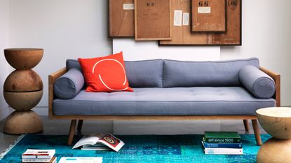 Mid-century modern sofa in grey with cork board wall