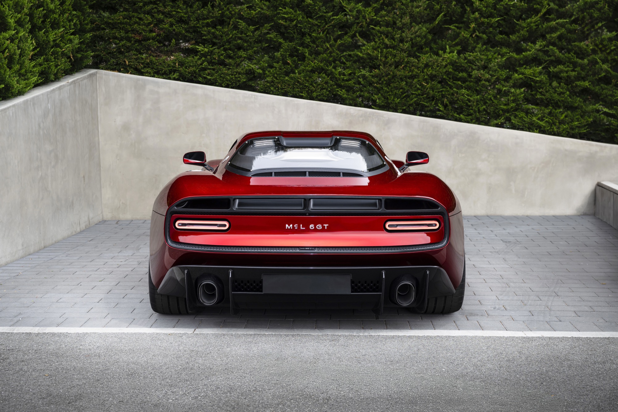 Details of the new McLaren McL6GT, finished in a deep red, looking like a 1970s American racer.