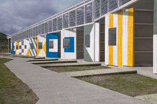 A range of angled walls with different yellow, white and blue geometric patterns