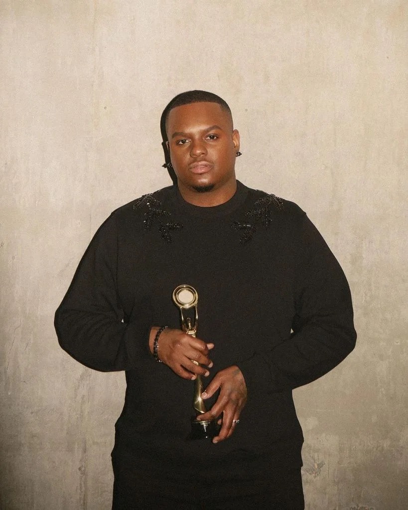 a black man in a black sweatshirt with glowing skin