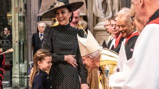 Catherine, Duchess of Cambridge laughs as she introduces her daughter Princess Charlotte of Cambridge to the Archbishop of Canterbury Justin Welby as they arrive at Westminster Abbey for the Service of Thanksgiving for the Duke of Edinburgh on March 29, 2022 in London, England.
