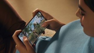 Young woman playing a game on the Oppo Find X5 Pro