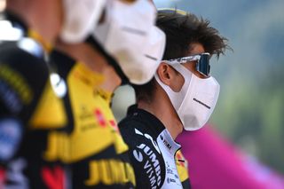 Riders wearing facemasks during a Grand Tour