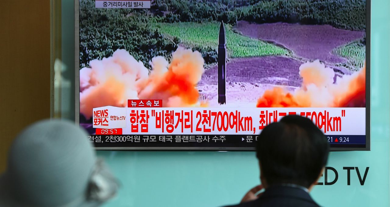 People watch news screen showing North Korean missile launch 