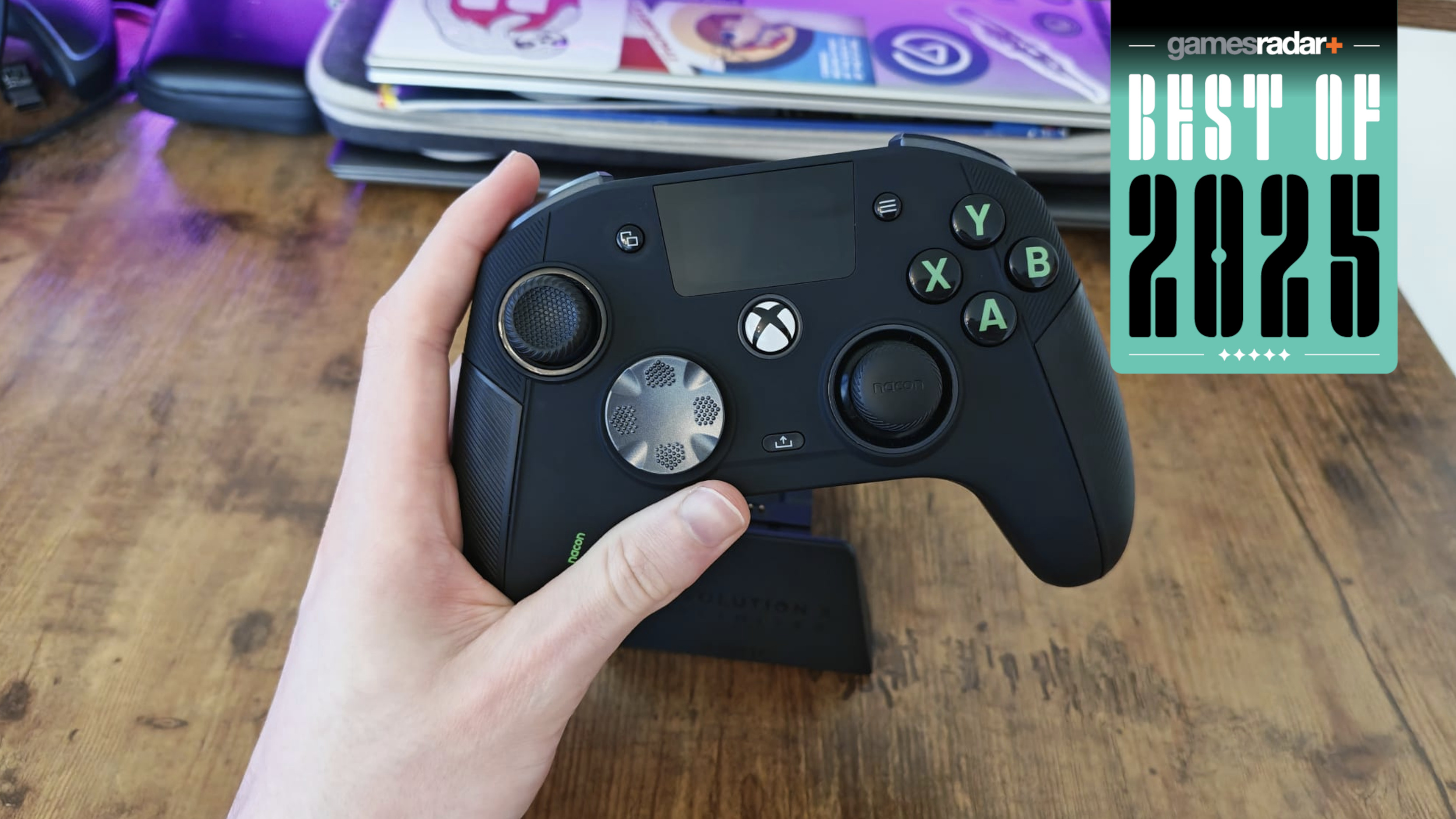Hand holding Nacon Revolution X Unlimited controller with 'best of 2025' badge