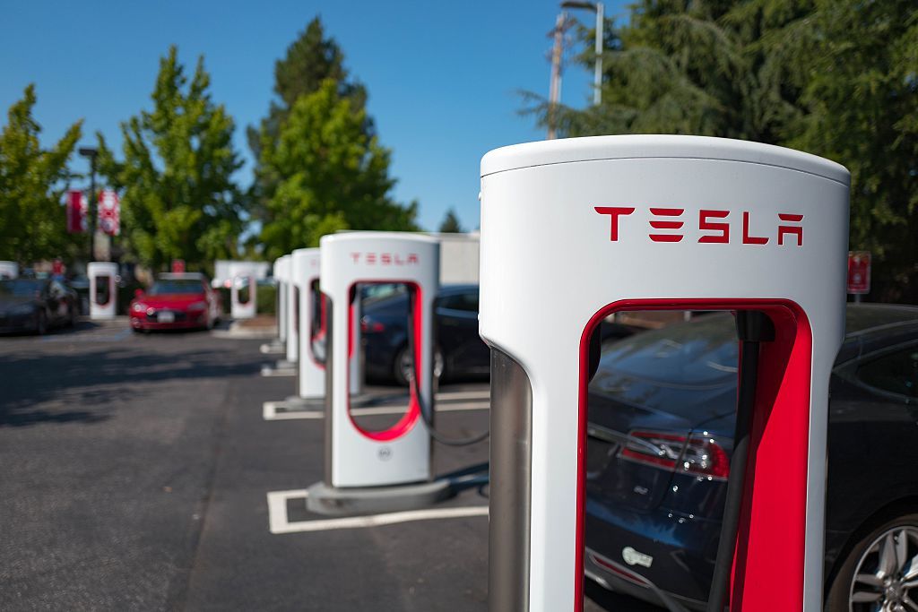 Charger with Tesla logo at a supercharger rapid battery charging station