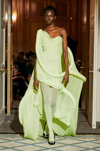 Woman on London Fashion Week runway in colourful Roksanda gown with sculptural loops