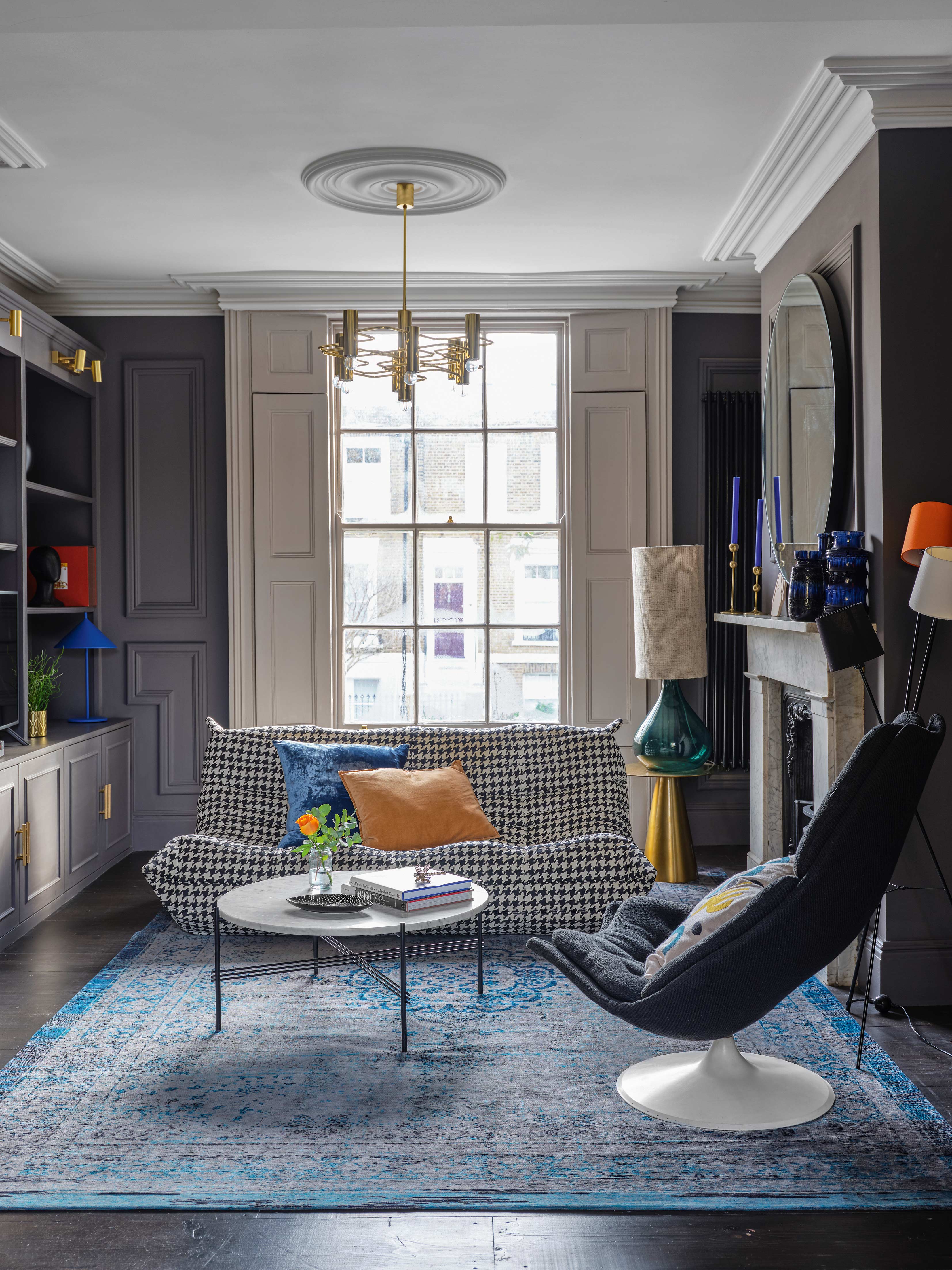 Modern living room with patterned sofa, retro furniture and built in shelving