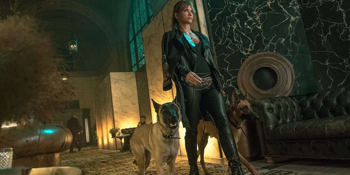 Halle Berry as Sofia strutting off with her dogs in John Wick: Chapter 3