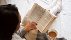 woman reading with cup of coffee