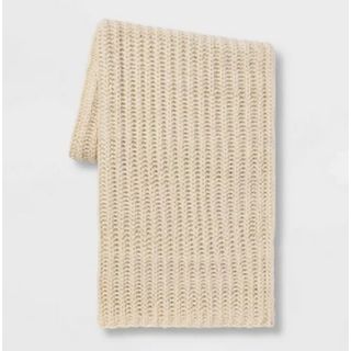 A neutral chunky knit throw