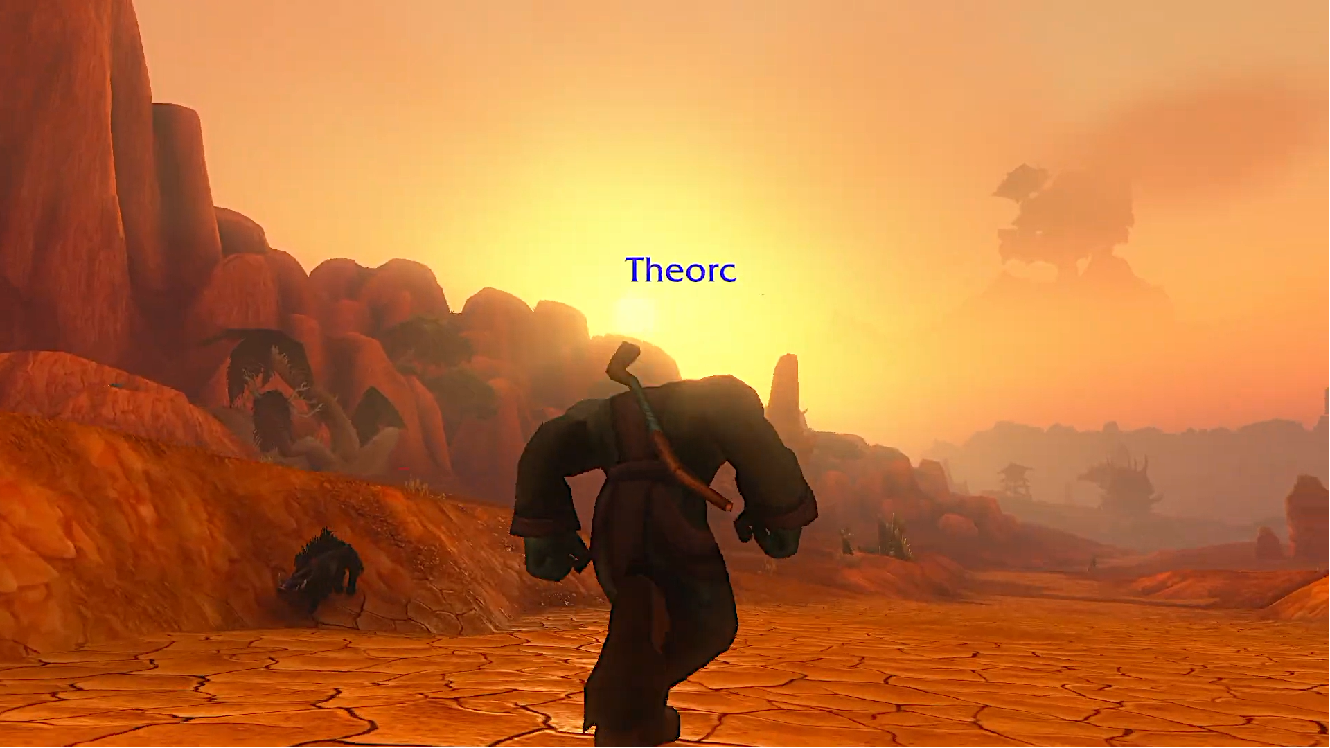 An orc running through a very pretty Durotar.