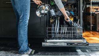 Dishwasher Cyber Monday deals: Image shows a person unloading a dishwasher.