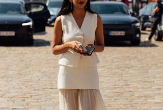 Woman in in white vest and skirt