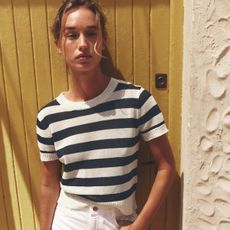 Zara model wearing a striped sweater and white jeans