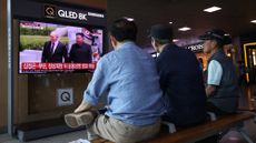 South Koreans watch a news report on the meeting between Kim Jong Un and Vladimir Putin on a TV screen at Seoul railway station